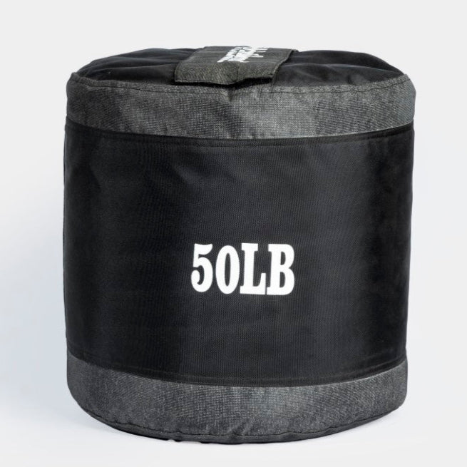 A black textured slam ball with the label '50LB' on it, indicating its weight.