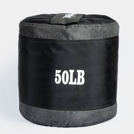 A black textured slam ball with the label '50LB' on it, indicating its weight.